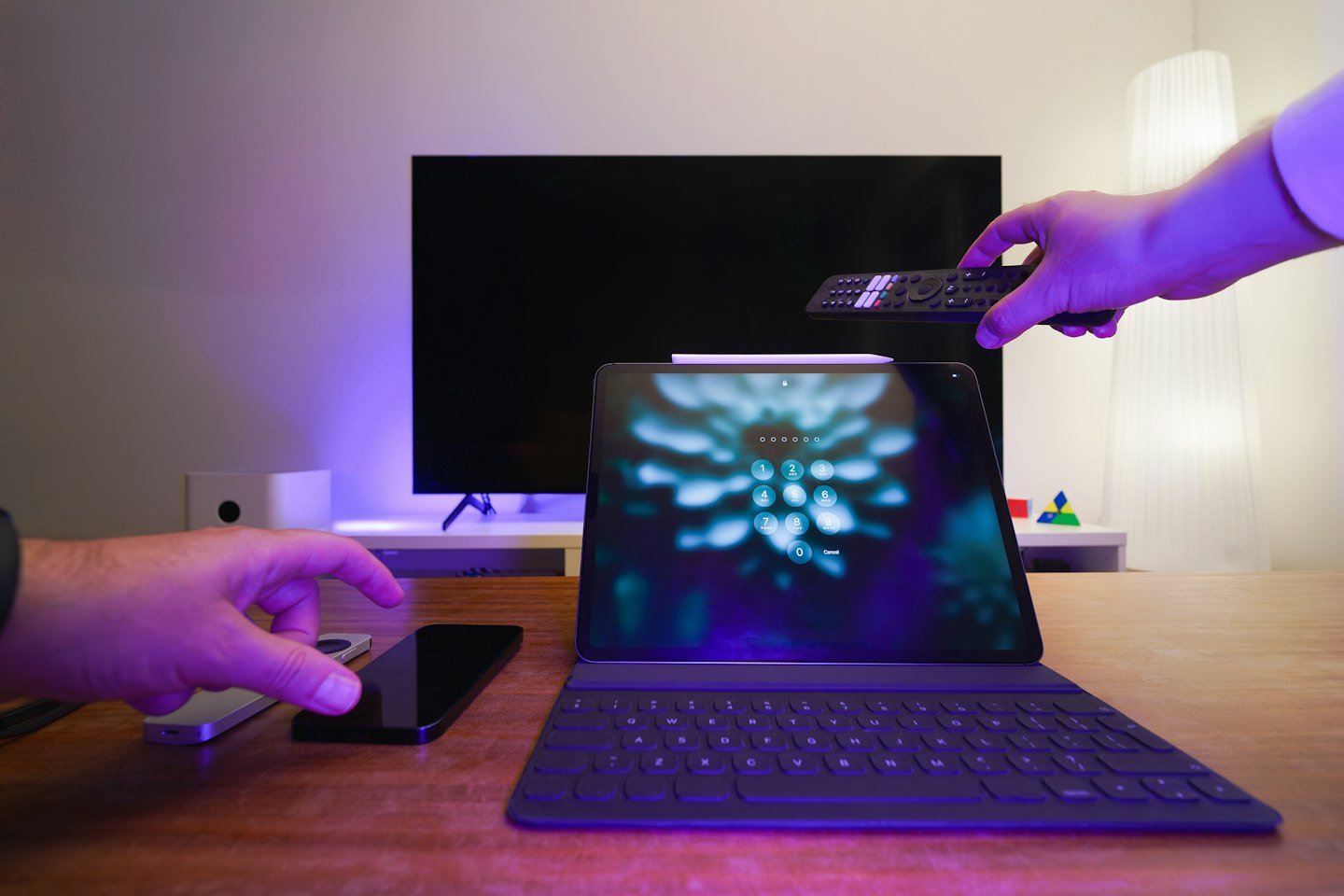 Mani che interagiscono con la tecnologia smart home su una scrivania.
